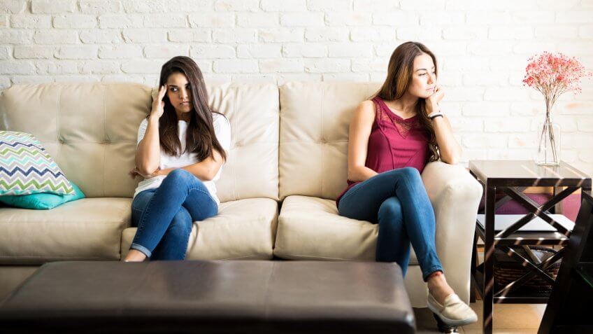 Female roomates and friends avoiding each other after having an argument at home.