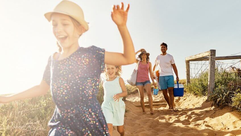 girl with family running on the beach