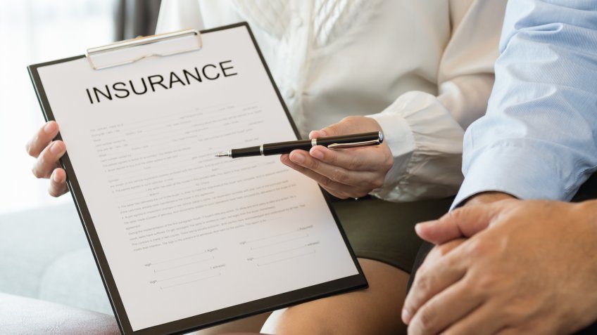 insurance agent pointing to paperwork