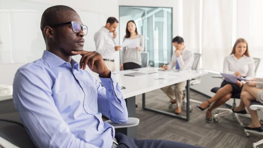 Businessman thinking during meeting in office.