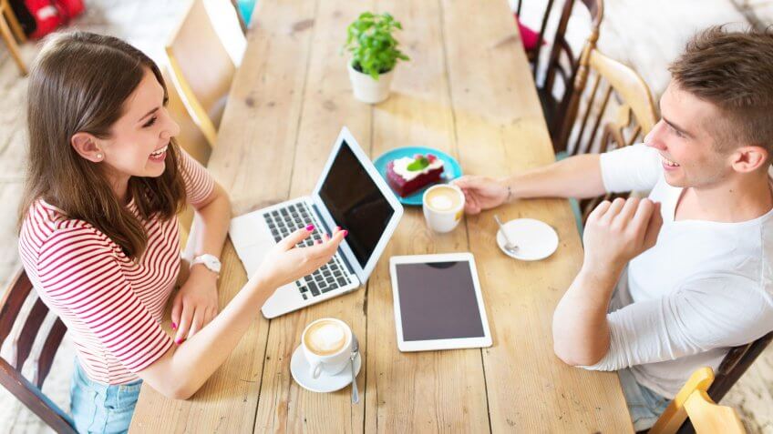 Young people working at cafe.