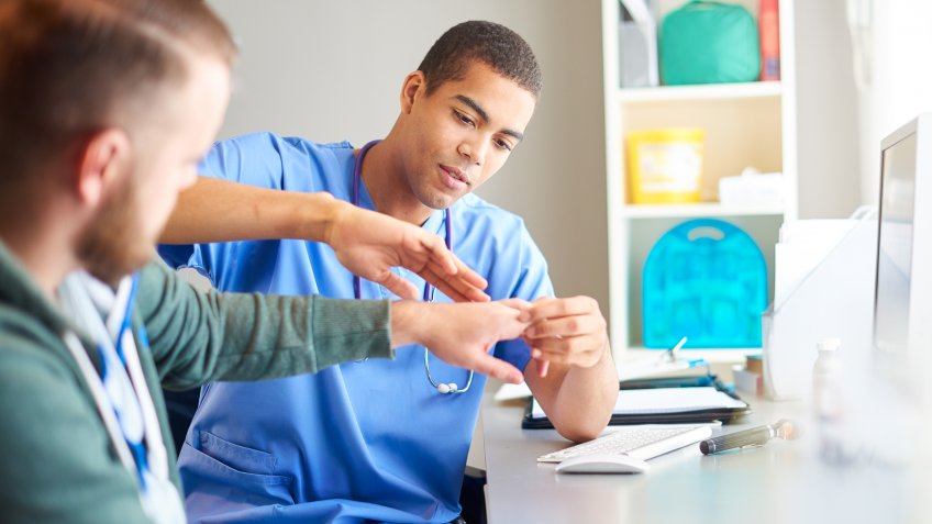 registered nurse examining patient hand