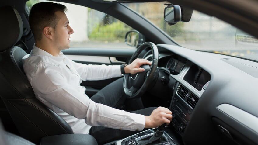man driving a car