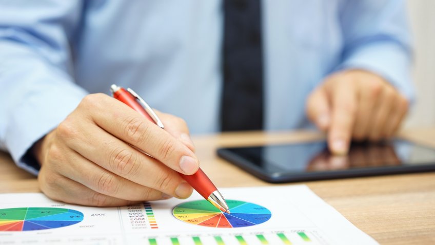 man pointing to pie graph chart