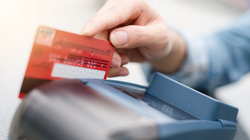 man swiping credit card