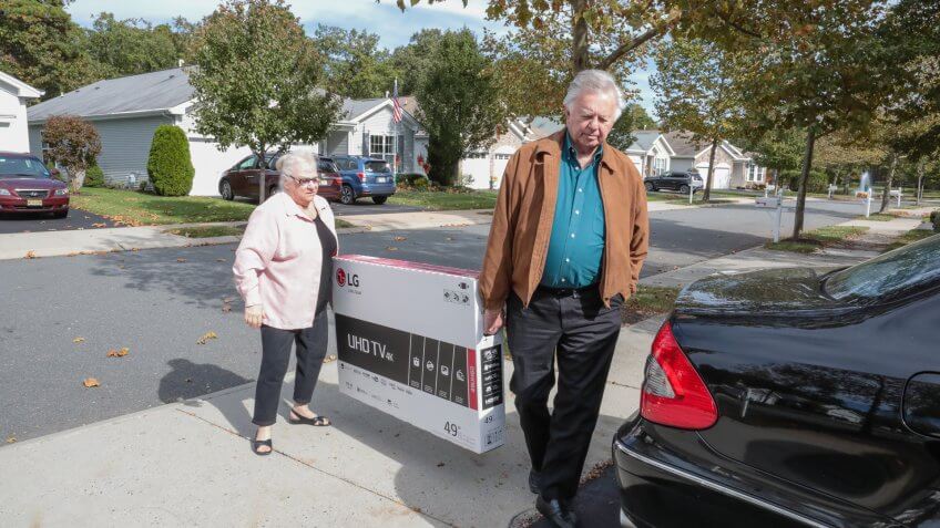 Galloway, United States - October 26, 2016: Series:Senior caucasian husband and wife have bought a new flat screen tv for there home.