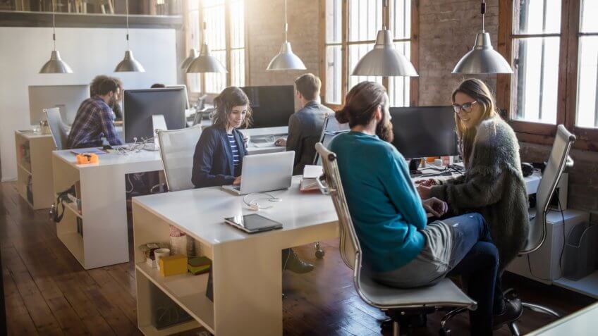 Young creative business people working in the office late in the afternoon.