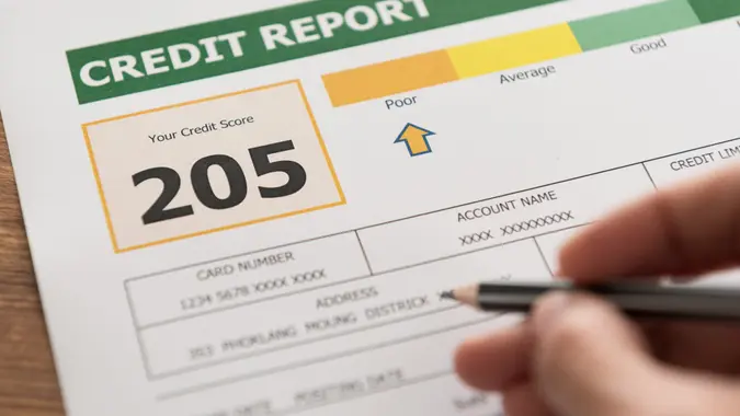 women checking credit score in credit history report.