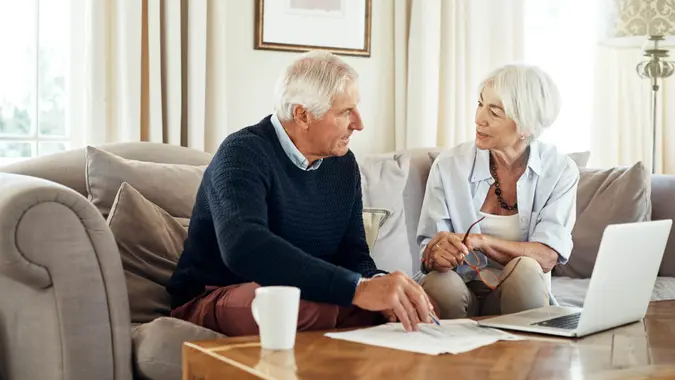 Shot of a senior couple going through their paperwork together at home.