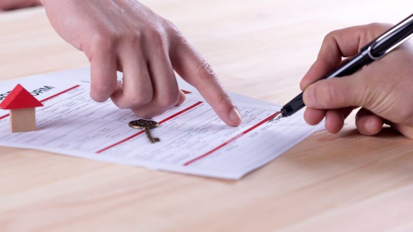 New homeowner signing contract of house sale or mortgage papers.
