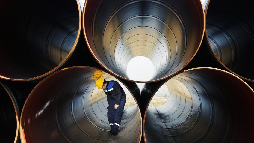 steel worker walking in steel pipe