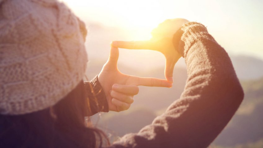 Future planning, Close up of woman hands making frame gesture with sunrise on mountain, Female capturing the sunrise, sunlight outdoor.