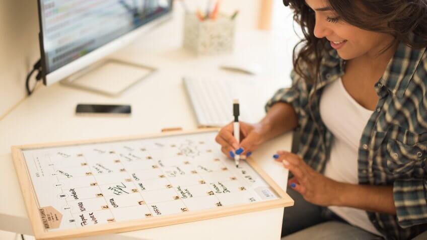 woman making notes in calendar