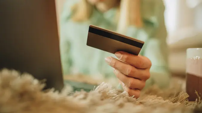 Close up of a woman using credit card and computer for a credit card
