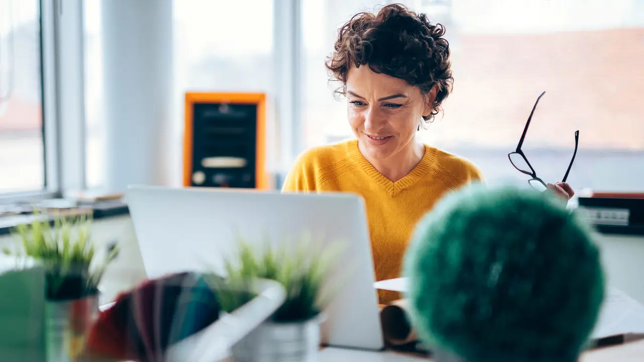 Woman happy with results seen on computer