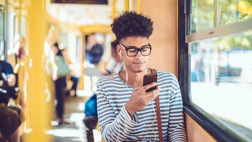 Young man checking messages on his smart phone.