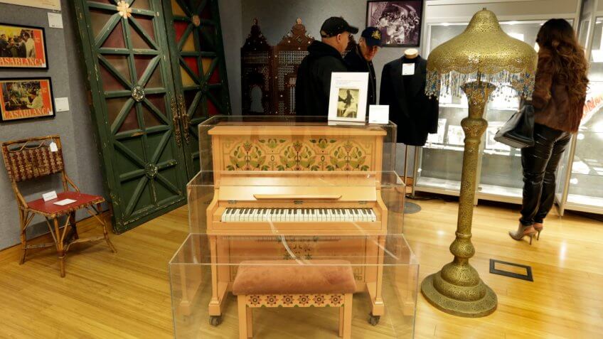 Photo by Richard Drew/AP/REX/Shutterstock This Nov. 21, 2014 photo shows the piano on which Sam plays "As Time Goes By," a bamboo and cane cafe chair the front doors of Rick's Cafe Americain, and a Moroccan-style painted metal floor lamp from "Casablanca," part of the "There's No Place Like Hollywood" movie memorabilia auction, at Bonhams auction house, in New York.