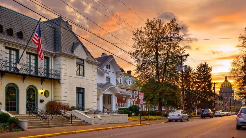 Residential street in downtown Charleston, West Virginia with the Capitol building in the background at sunrise.