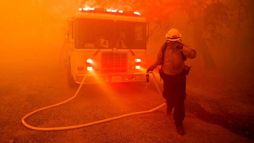 Photo by Noah Berger/AP/REX/ShutterstockA firefighter rushes to save a home as the River Fire tears through Lakeport, Calif.