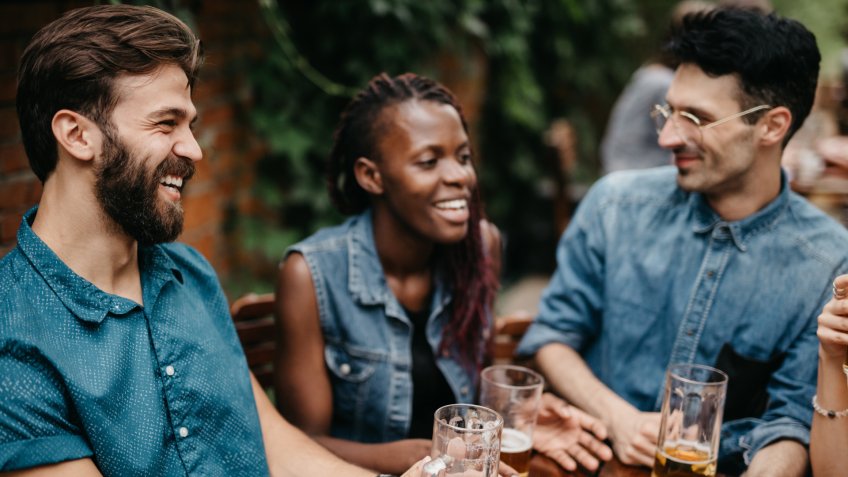 Friends burst in laugh at the pub