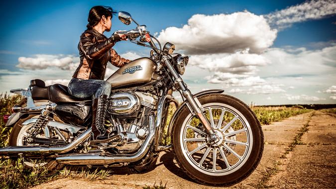RUSSIA-JULY 7, 2013: Biker girl and bike Harley Sportster.