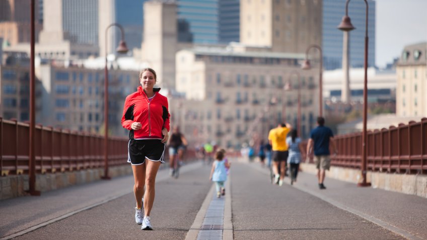 Jogger crossing Minneapolis' famous stone arch bridge