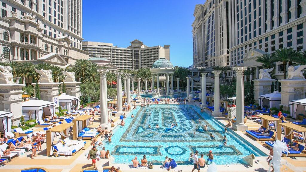 "Luxury, Architecture, Caesar's Palace, Casino, City, City Life, Clear Sky, Color Image, Comfortable, Day, Famous Place, Group Of People, Heat, Hotel, Image, Indulgence, Large Group Of People, Las Vegas Metropolitan Area, Nevada, Pool Party, Reclining, Relaxation, Spring Break, Summer, Summer Resort, Sunbathing, Swimming Pool, Swimwear", The Las Vegas Strip, Tourist Resort, Travel Destinations, USA, Urban Scene, Vacations, crowd, party, people