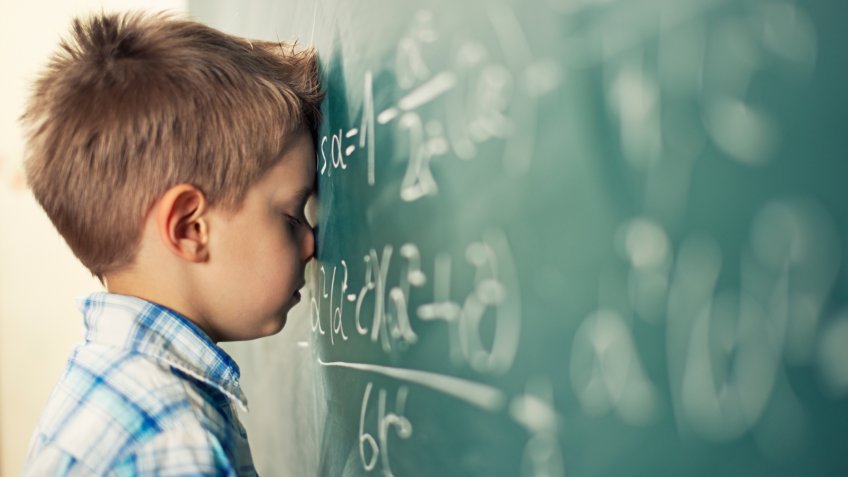 Little boy in math class overwhelmed by the math formula.
