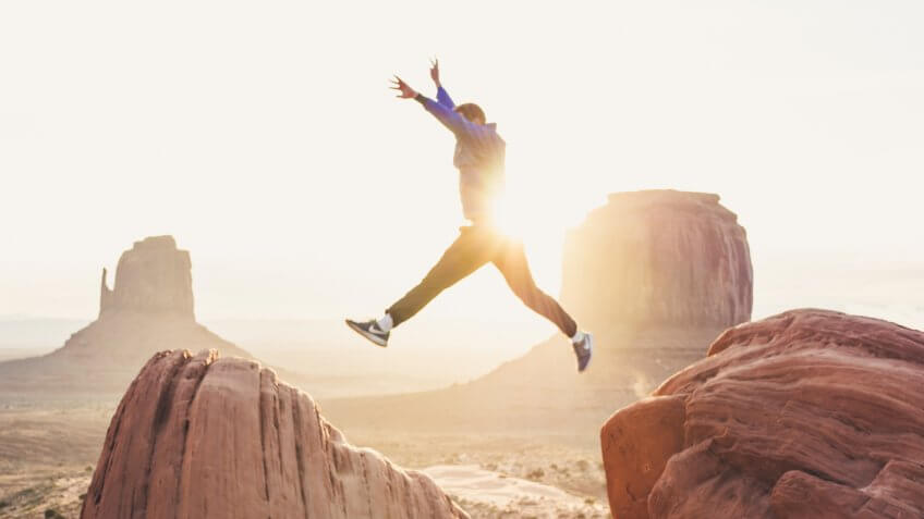 Man jumping off cliff in Arizona