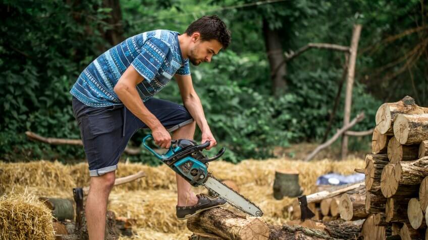 Man chopping wood with a chainsaw