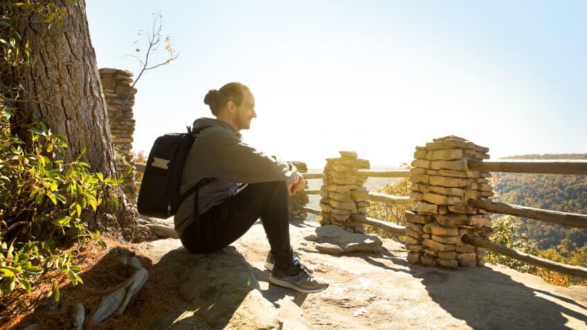 A man enjoying a beautiful fall morning outdoors.