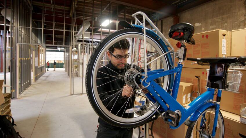Philadelphia, PA, USA - March 31, 2015; Philly Bike Share Head Mechanic Jake Siemiarowski is seen assembling an Indego Bike for the Philly bike share program, at the Indego Headquarters in the Northern Liberties neighborhood of Philadelphia.