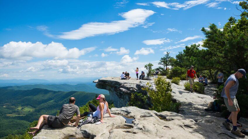 Catawba, Virginia, USA - September 1, 2014: Hikers enjoy the view of the Appalachian Mountains from McAfee Knob on Catawba Mountain, near Roanoke, Virginia.