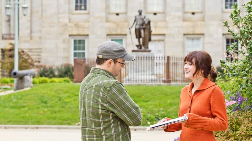 Man Listening to Young Woman Petitioner