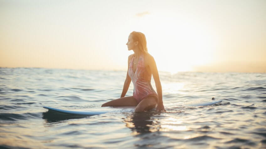 Surfer girl in the ocean in Hawaii