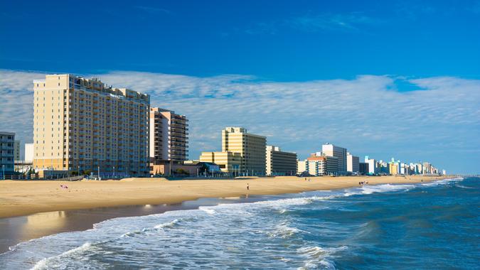 Virginia Beach’s coastal skyline with hotels and condominium towers, and with the Virginia Beach coastline and people in the foreground.