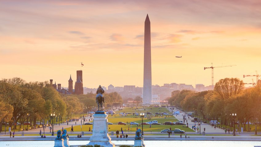 Washington DC city view at a orange sunset, including Washington Monument from Capitol building.