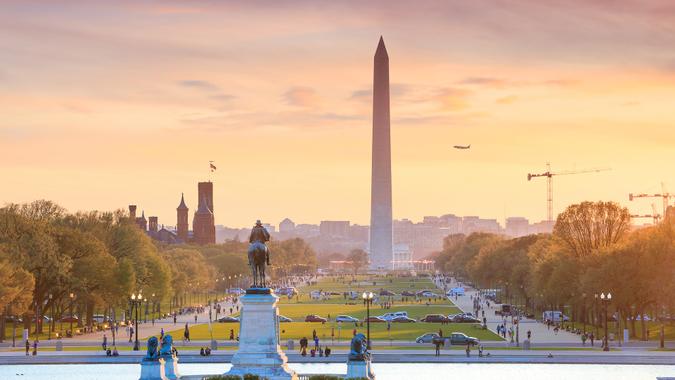 Washington DC city view at a orange sunset, including Washington Monument from Capitol building.