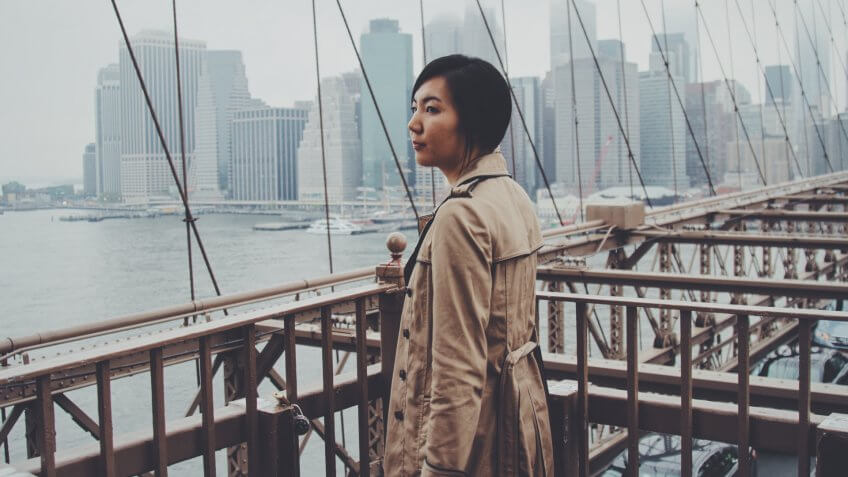 Woman in trench coat taking in the view of New York