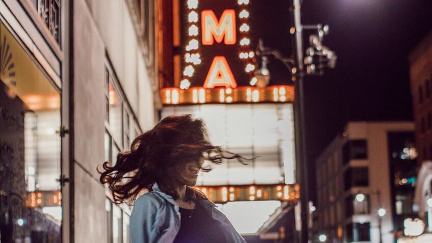 Woman spinning in front of Alabama Theater