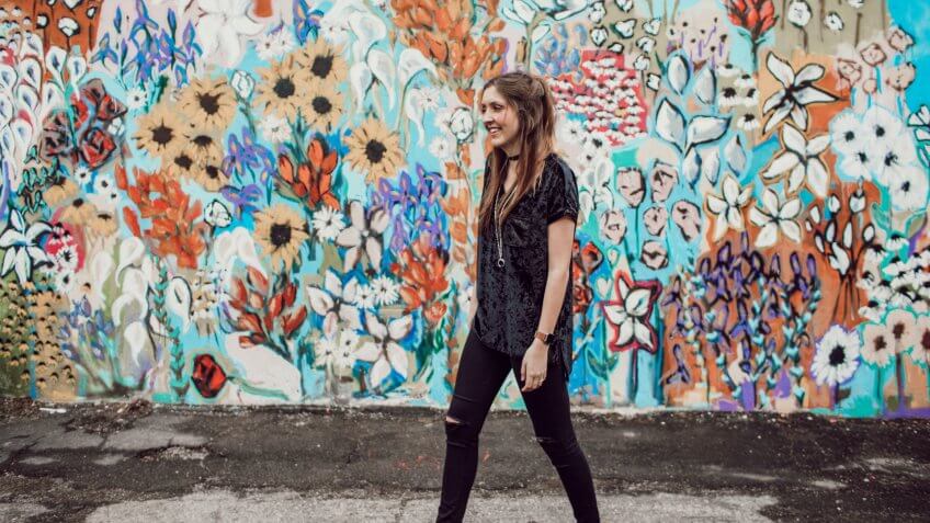 Woman walking past a colorful mural in Tennessee