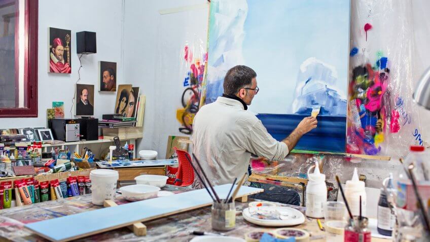 Mature artist businessman on his art studio.