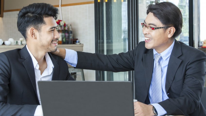 Two of business man sitting at the office desk.