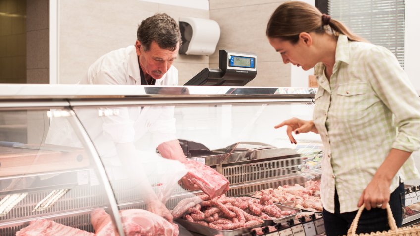 woman buying meat at the butcher shop.