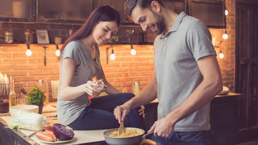 Young beautiful couple in kitchen.