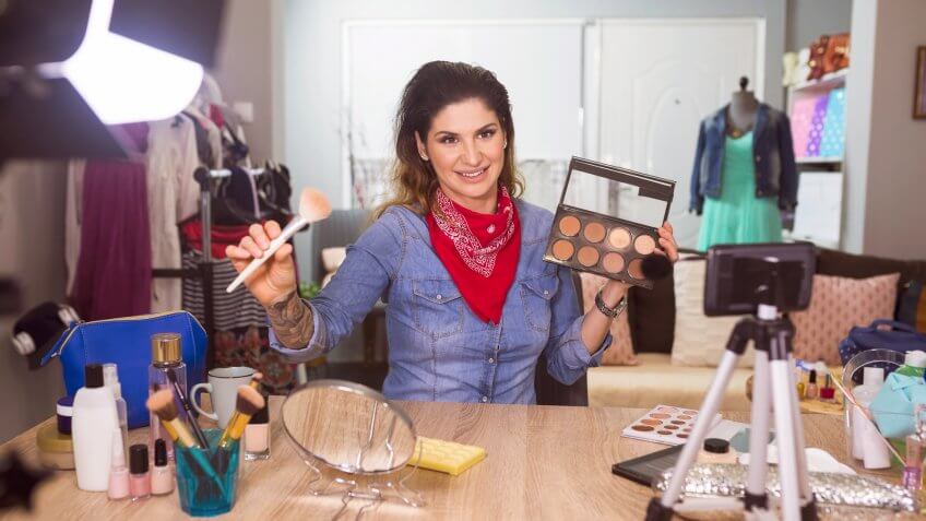 Fashion stylist vlooger filming in fashion studio.