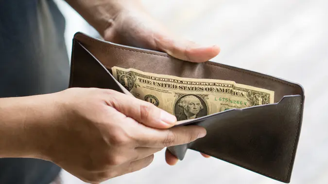 guy with one dollar in wallet