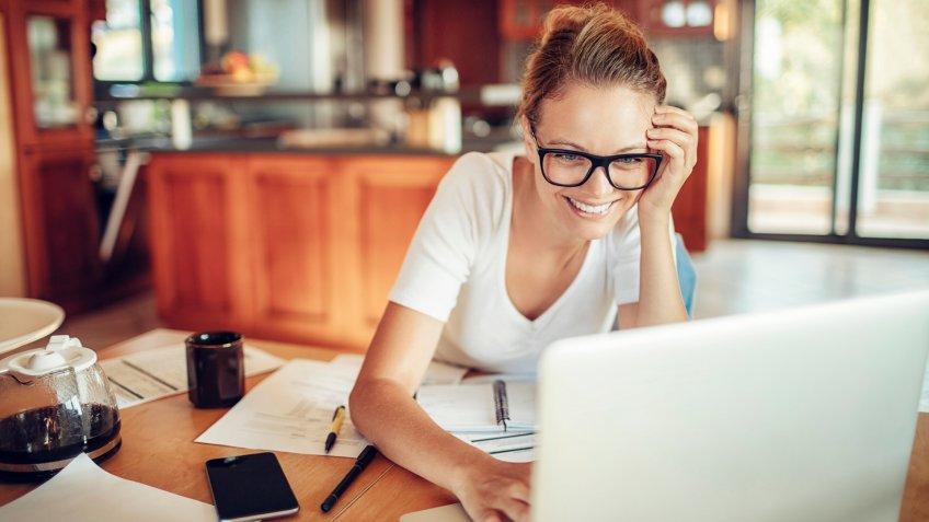 woman using a laptop in the kitchen.