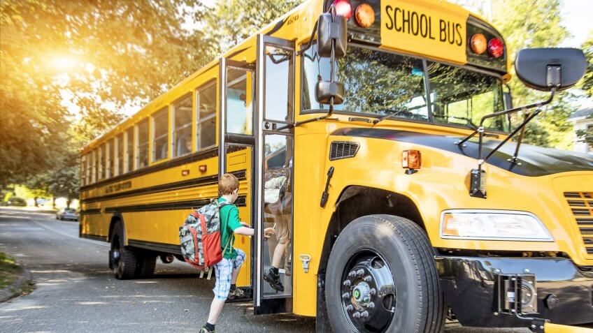 kids getting on a school bus