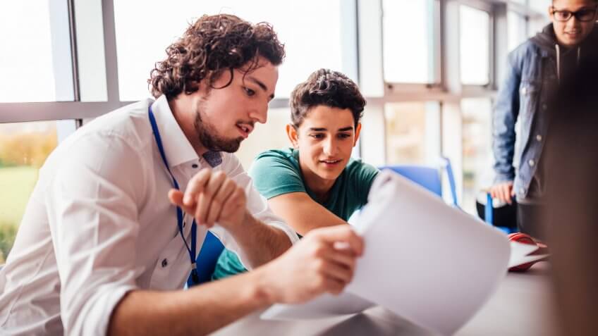 Teacher showing a student some results on his paperwork.